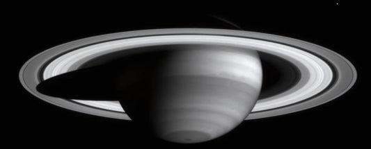 A black and white image of Saturn showcasing its rings
